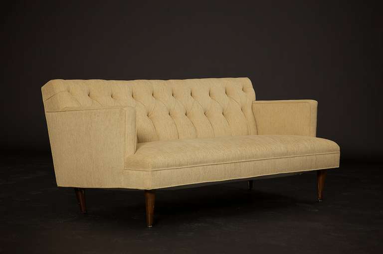 A gorgeous sexy, circa 1960s two-arm tufted sofa. The sofa has a firm seat and back rest. We love the strong-arm profile of this sofa. (Please see the matching two-piece sofa and chairs in our other listings). 

They are expertly finished in a