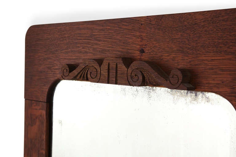 Nice dark oak grain and patina makes this 19th century mirror a great addition to mostly any decor. We especially love the quaint hand-carved scroll work on both ends.