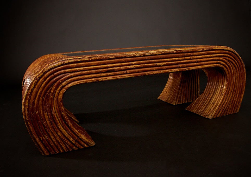 This table, attributed to Paul Frankl, has great character, is stylish, timeless and in great condition for its age. Of course, the bit of wear on the finish gives it an even more magnificent look, circa 1930s, it has a seamless inset, clear glass