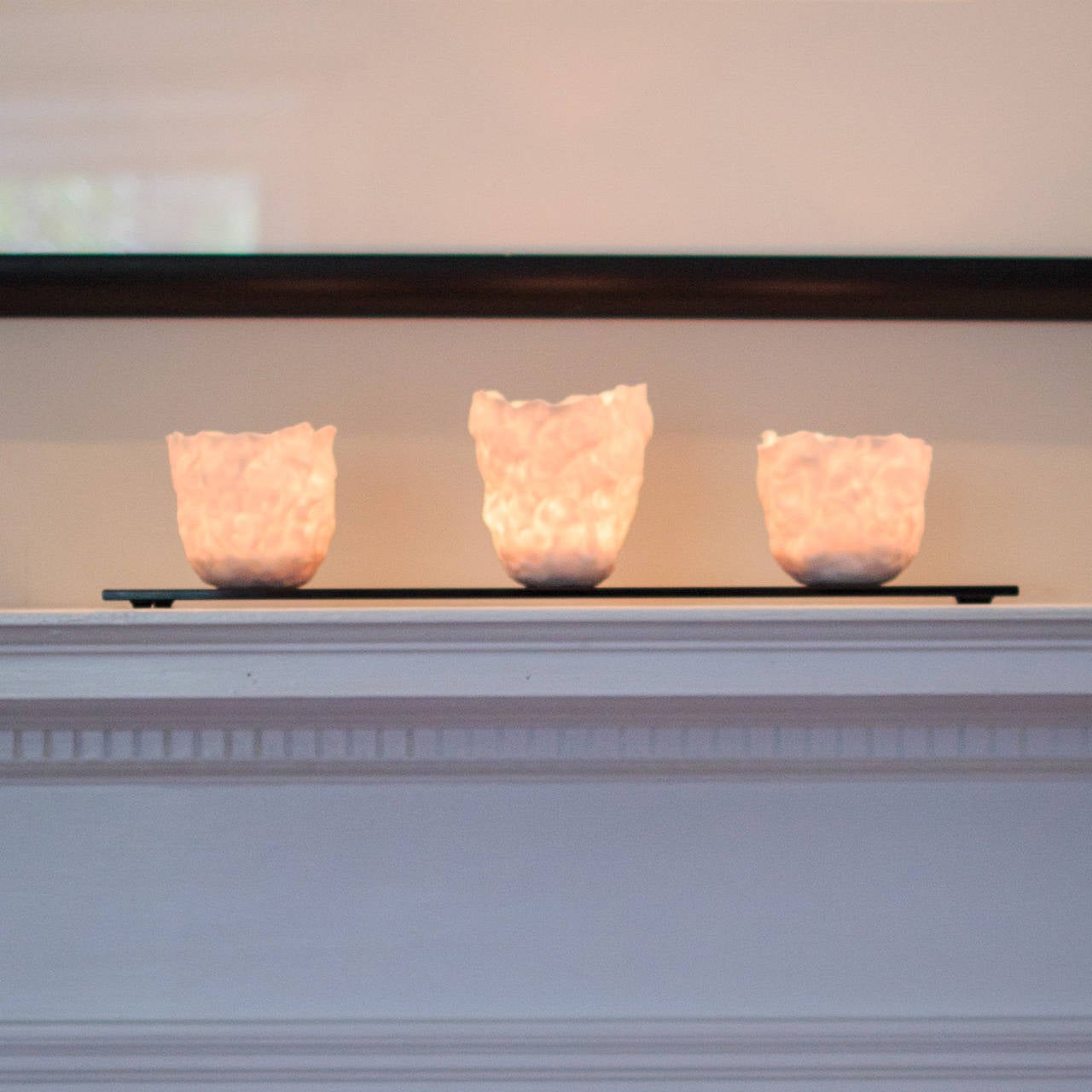 This beautifully handcrafted votive centerpiece is by the ceramic artist Gabriella Levy. Made of fine, translucent porcelain and hand-poured soy wax, the votives glow warmly when lit and create the perfect ambiance for any table or mantel. When the