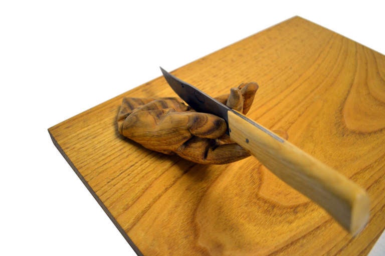 This limited edition, fully functional chopping block by Juan Muñoz offers a disquieting quasi-narrative. The hand motif, seen here in a most literal use, reoccurred often in the artist's body of work. Chopping Block features a hand-carved, wooden