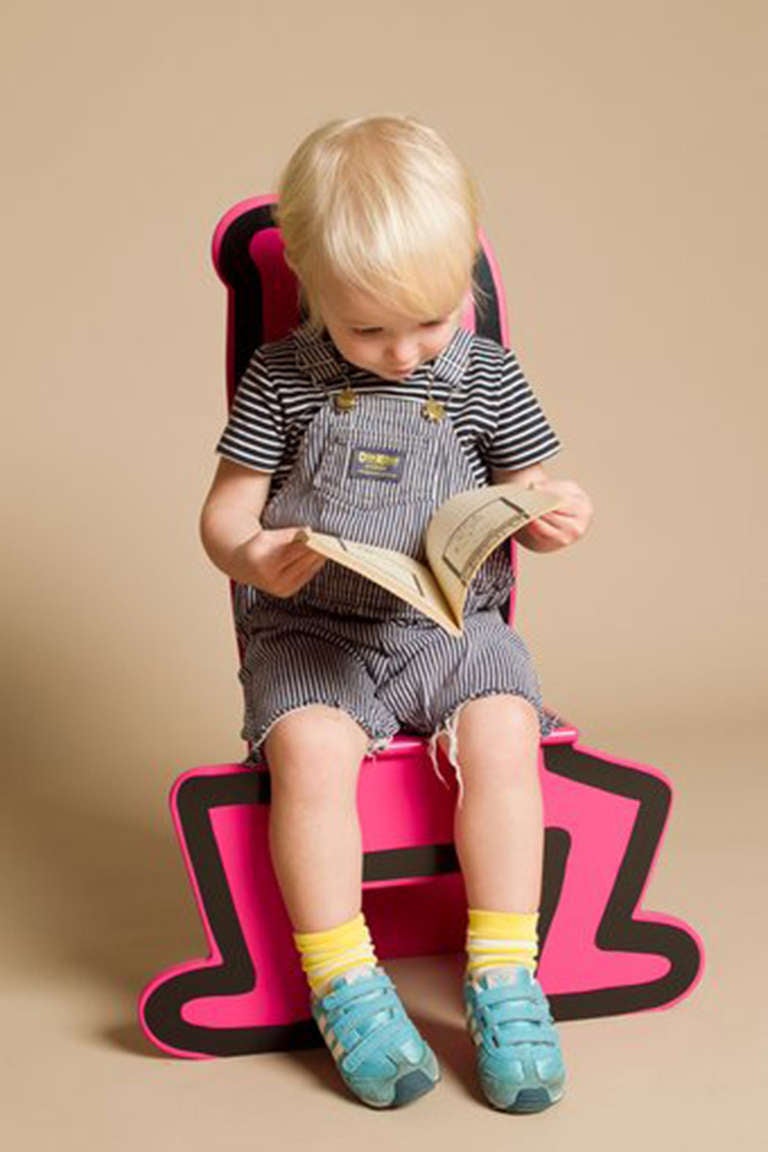 Please indicate color upon order: red, yellow or pink.
This brightly colored chair sized for a toddler features the artist's trademark image, produced in collaboration with the artist's estate. It's a great piece for a kid's room or play room. Minor