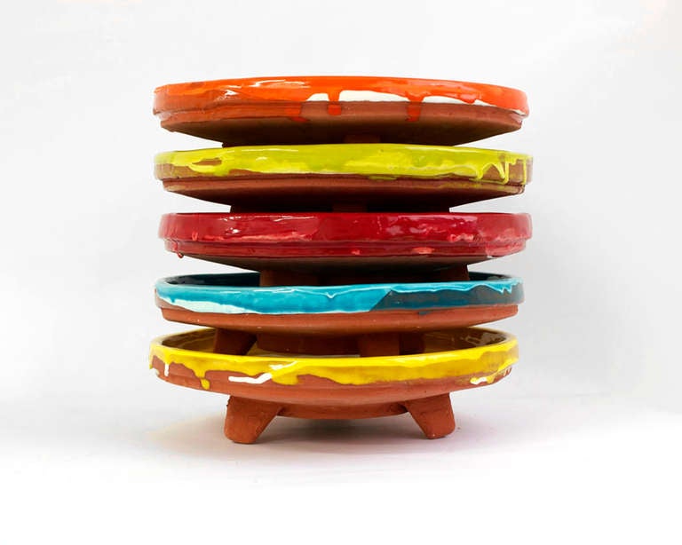 Steve Keister's line of functional terracotta wares are hand-cast and hand-painted by the artist. The shot glasses, cups, tumblers, vases and plates all sport brightly colored, glossy, food-safe glazes and are simple, geometric forms that make any