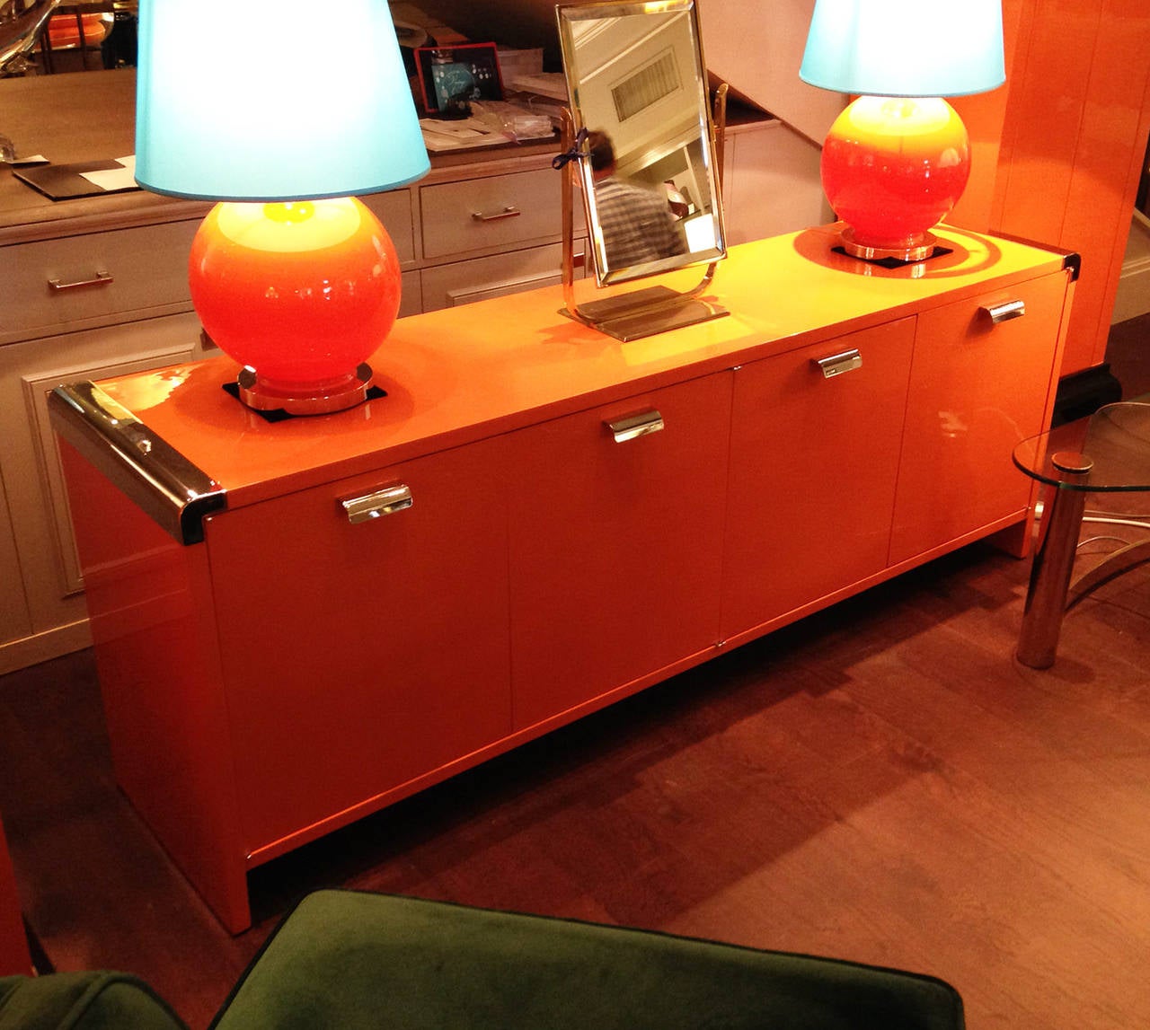 Vibrant orange lacquer with chrome accents. Three drawers each side.