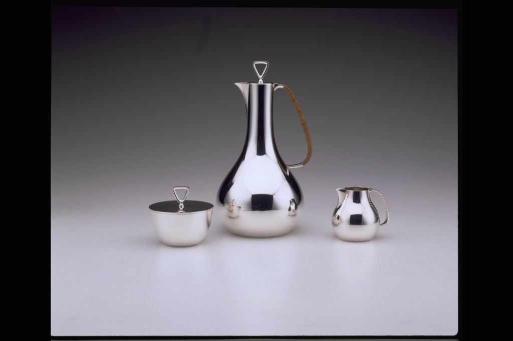 Very stylish Georg Jensen three piece coffee set designed by Sigvard Bernadotte in 1952.  This set is from the original production in 1952.<br />
<br />
Coffee pot - height 9 inches (22.9cm)<br />
Sugar bowl with cover - height 3 inches