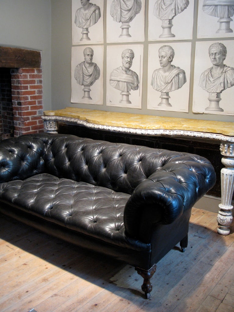 A very elegant and comfortable, late 19th century/turn of the 20th century English leather chesterfield, retaining the original leather (possibly), in great condition, that will work well in any setting, either classic or contemporary. 
Wonderful