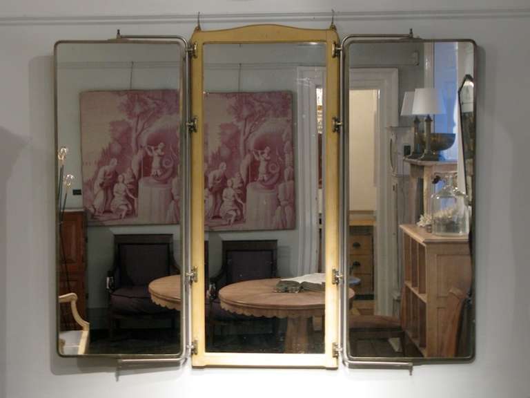 A very stylish and practical, circa 1930s French Triptych folding mirror, of great quality, retaining the original mirror glass panels, the centre one been bevelled. 

The side mirrors are adjustable. The metalwork stamped J D.