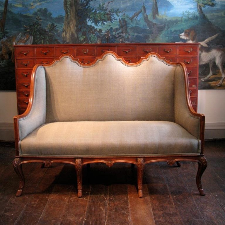 A fine quality, and recently reupholstered, late 19th century French high back walnut sofa, with great detail, on eight legs terminating in hoof feet.
This elegant sofa has been reupholstered in a silver/green linen, and will make a statement in