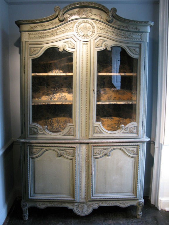 A great quality, and retaining the original paint, early to mid 19th century French Buffet du corps, with fine carving and still retaining the original glass panels. 
The upper section interior lined with 19th century Toile du Jouy fabric , and