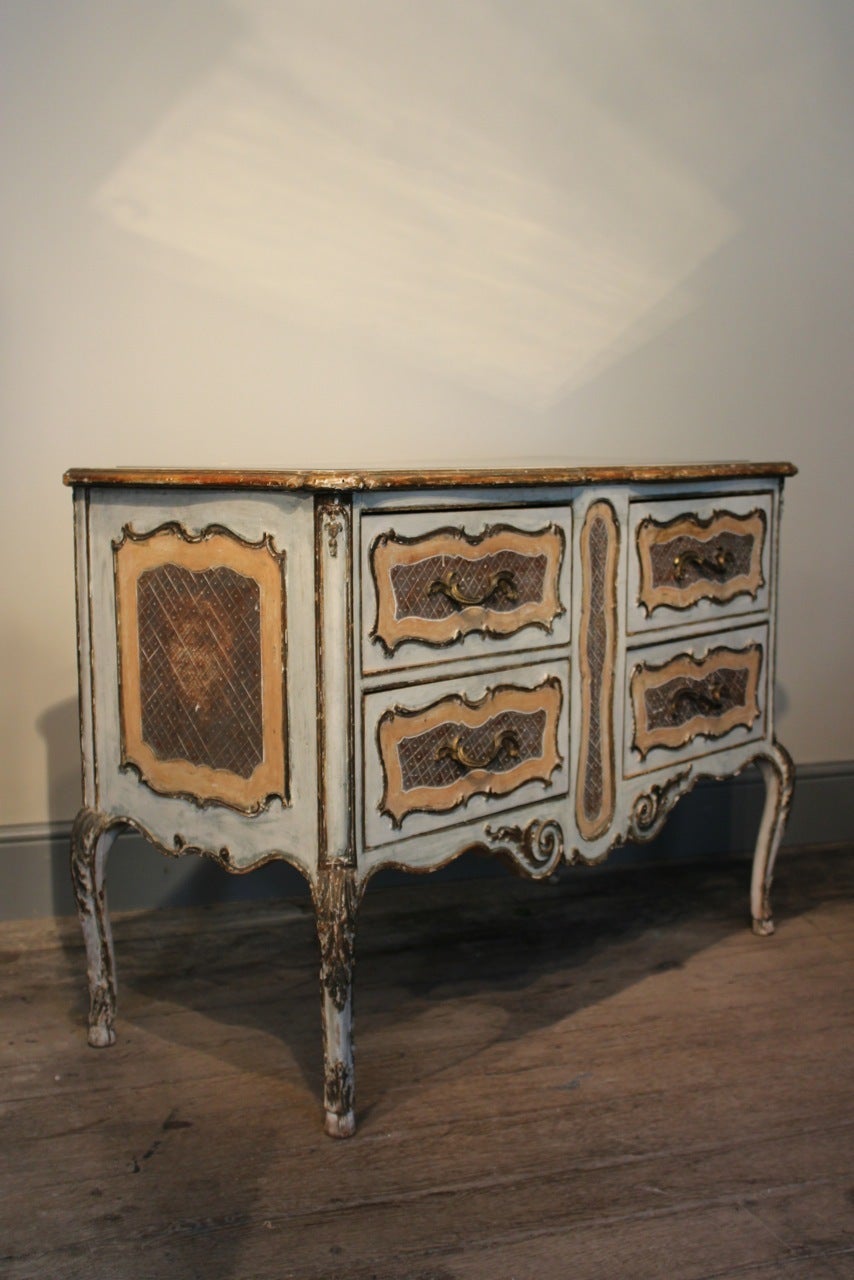 A very elegant, circa 1950s Italian commode in the 18th century taste, retaining the original pale paint and gilding and the original mirrored top. This painted commode will maker a statement in most settings. Italy Circa 1950.