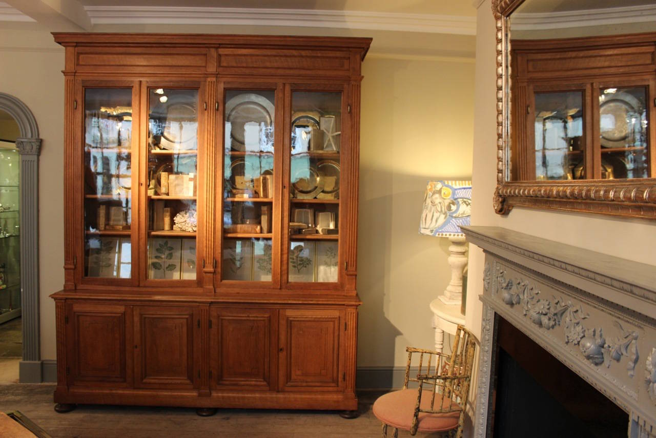 A great quality and retaining its original glass panels, 19th century oak bookcase of elegant proportions, with a lovely color and adjustable shelves, that will work well in most settings. 
Great detail on the brass hinges.