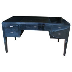 A 1930's black lacquered four drawer desk