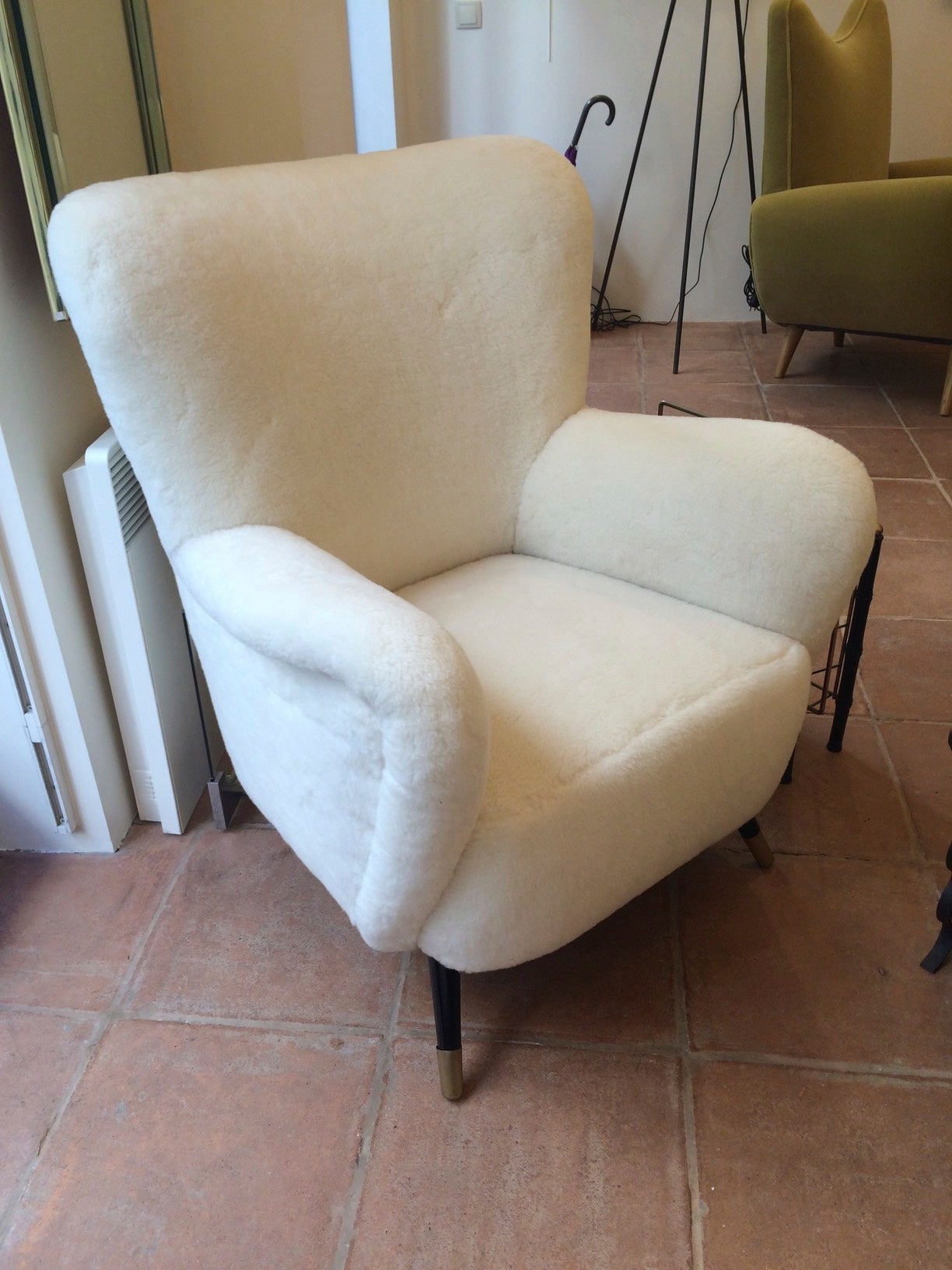 Style of Gio Ponti set of one couch and two chairs newly covered in raw white wool faux fur and bronze end legs.