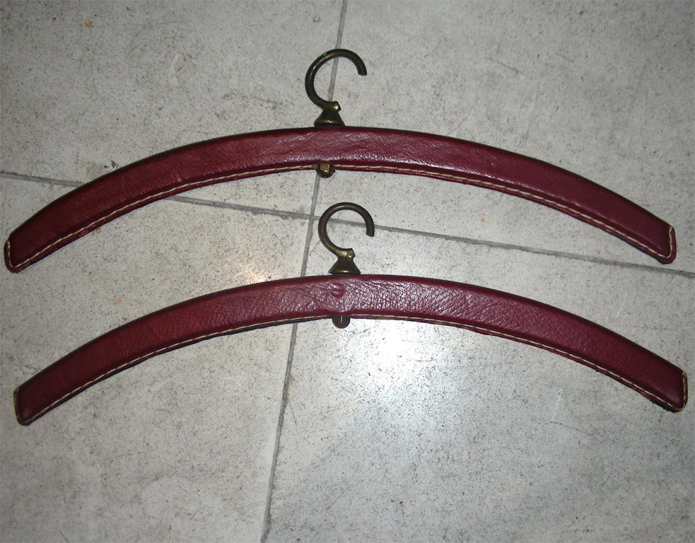 Mid-20th Century Jacques Adnet Rare Pair of 'Hermes Red' Stitched Leather Shelves and Two Hangers For Sale