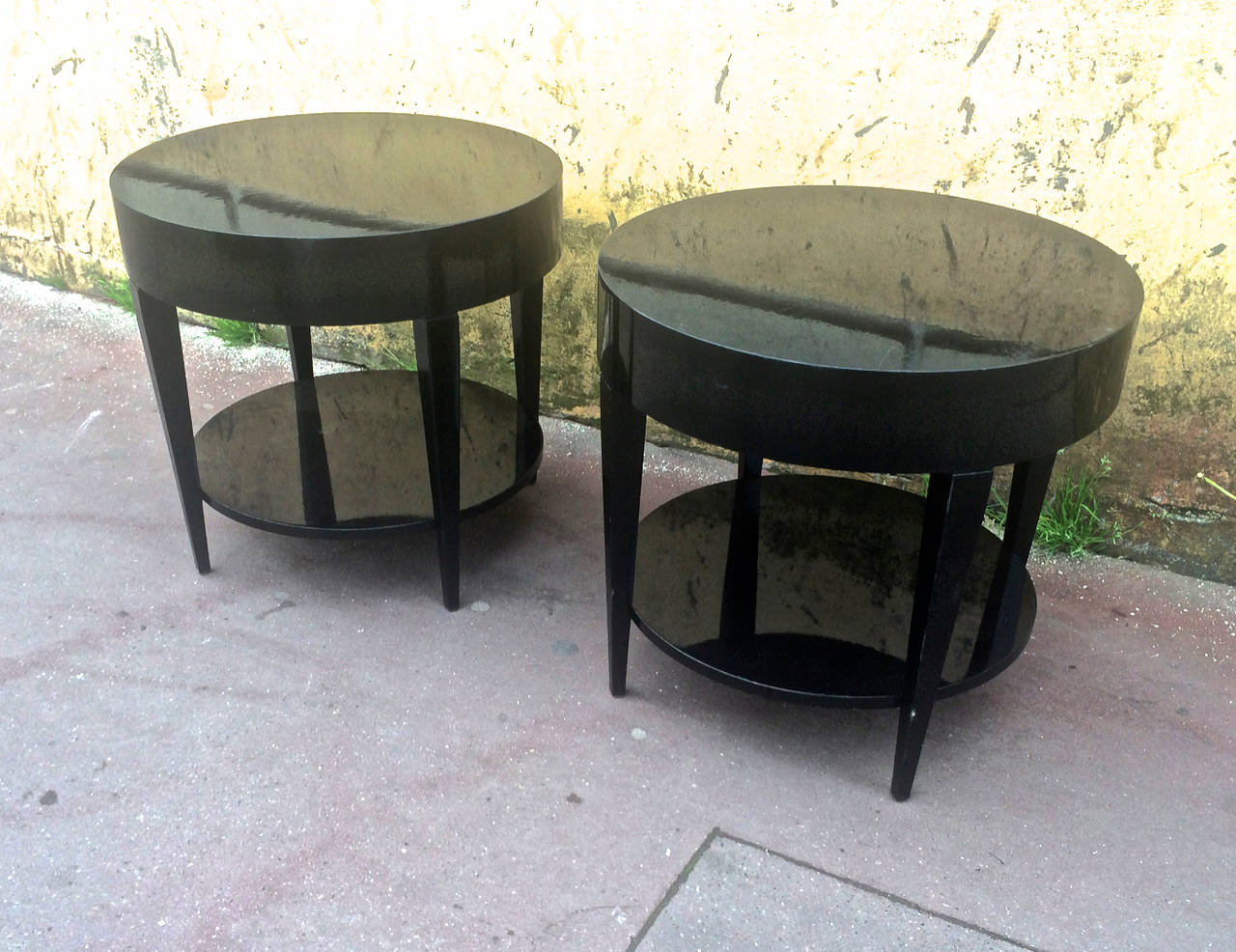 Black lacquered pair of two-tier side tables.