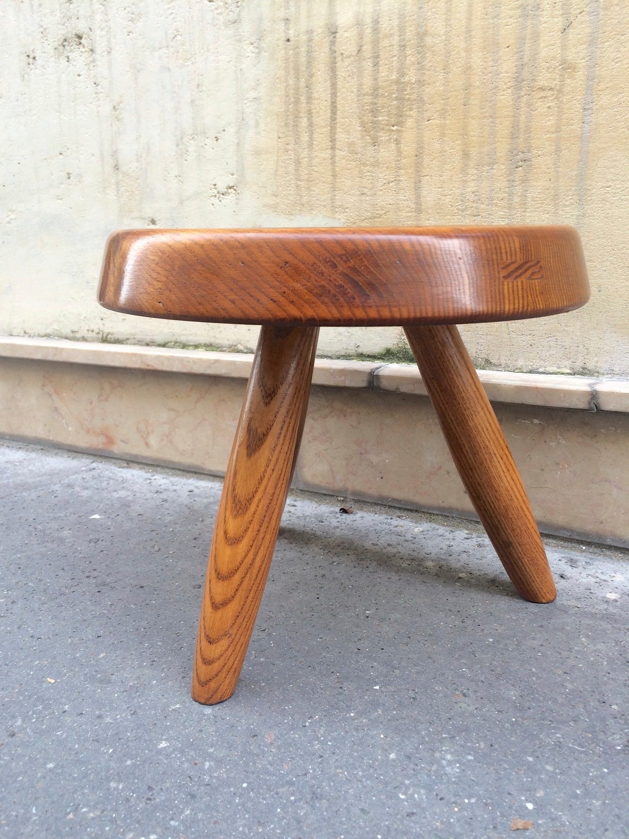 Charlotte Perriand ash tree tripod stool in vintage condition.