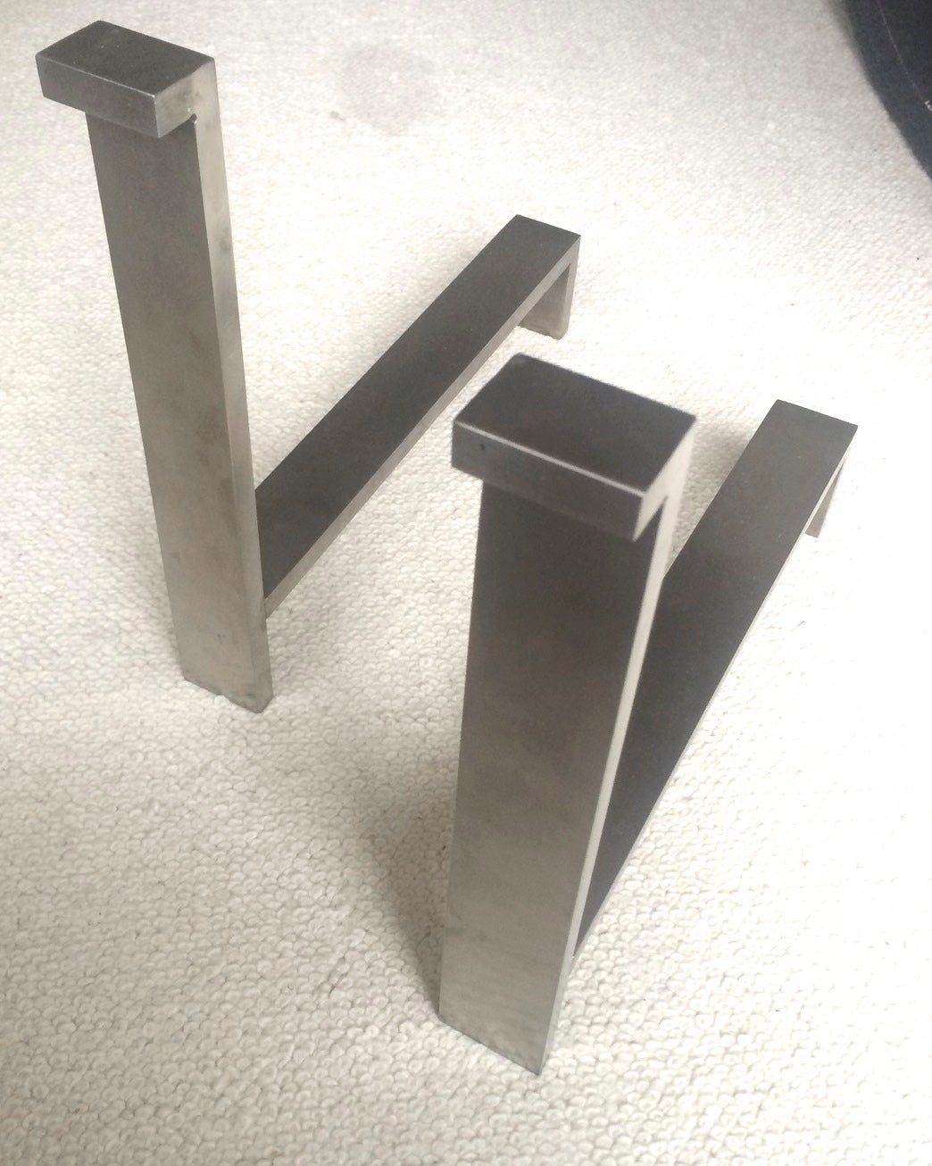1970s brushed steel pair of andirons with a very pure design.