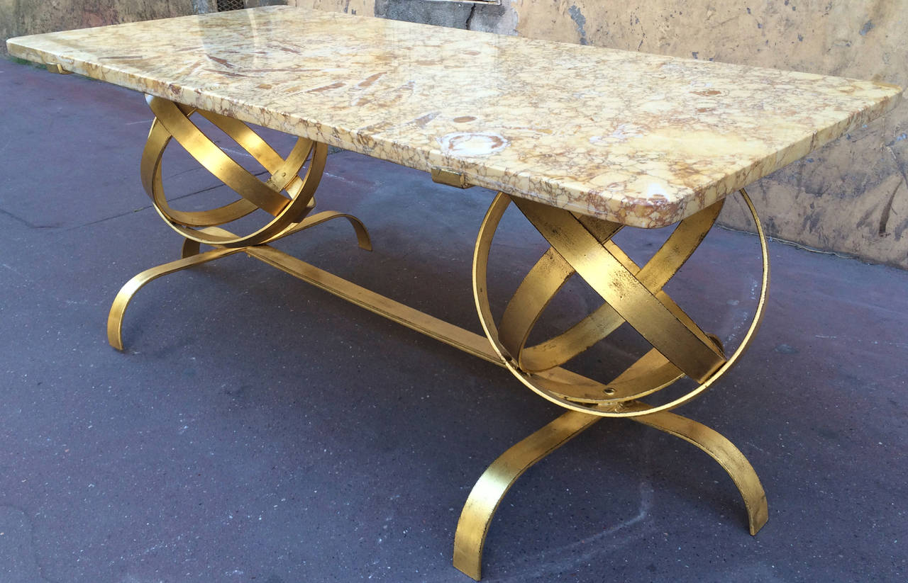 Spectacular two globes gold leaf coffee table with fossil marble top.