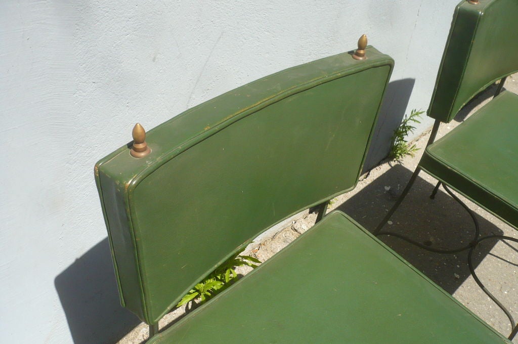 Set of chairs by Maison Jansen in green leather and wrought iron.