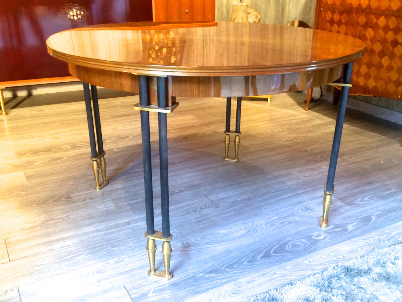 Jules Leleu documented 1950s superb design round dining table with a walnut,
sunburst top, bronze and cannonball legs.
Extendable with many leaves, we only have one.

The refined matching buffet is visible on our site.