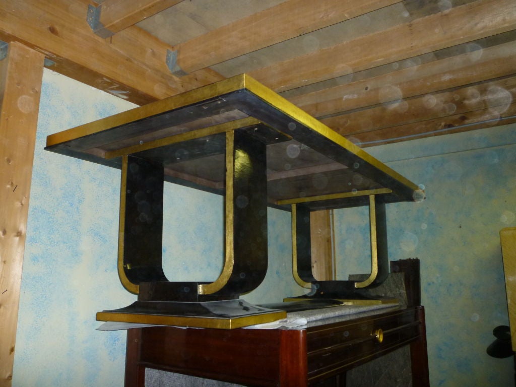 Art Deco long dining table in black lacquer and gold leaf sides.