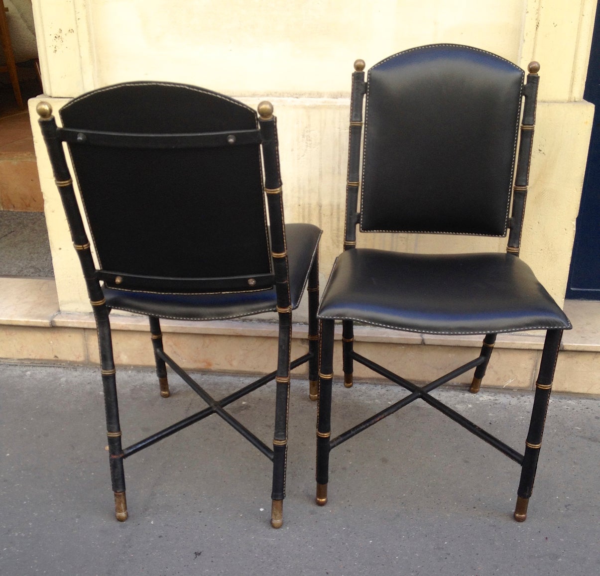 Jacques Adnet rare vintage pair of hand-stitched black leather chairs.