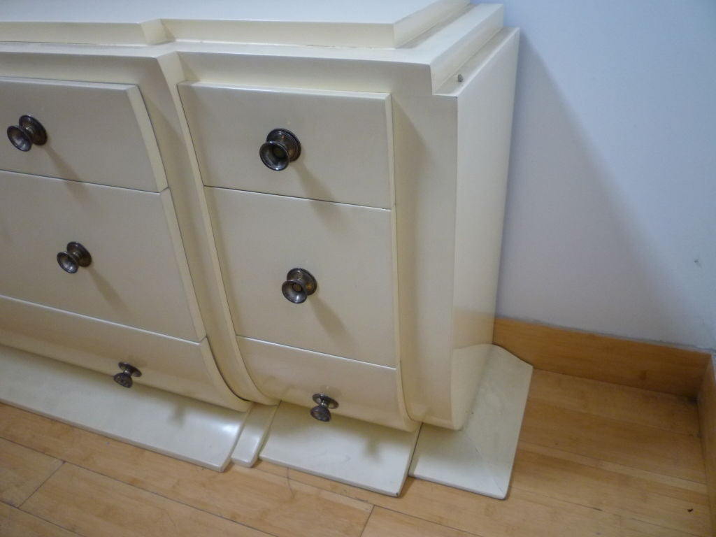 Extremely rare and early commode by Andre Arbus (documented and dated 1930 in the book
Andre Arbus) in cream laquer and silvered knobs with nine drawers with interiors in mahogany.
