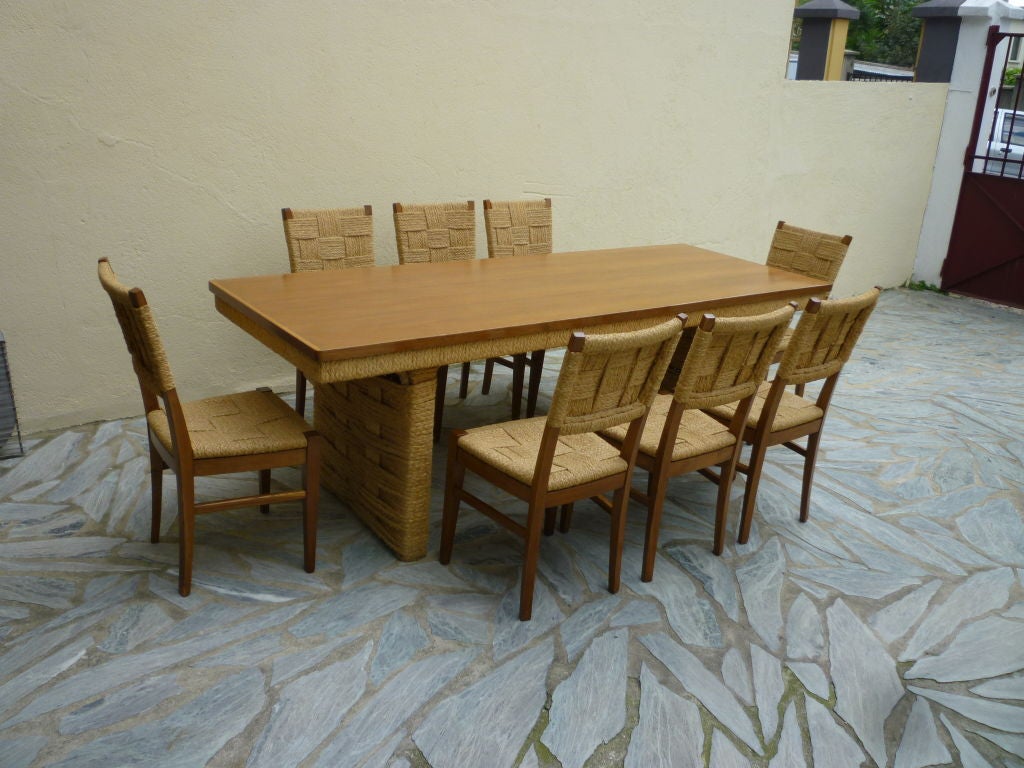 Exceptional dining set by Audoux Minet with a seven feet long dining table and,
a set of eight chairs in good vintage rope condition.