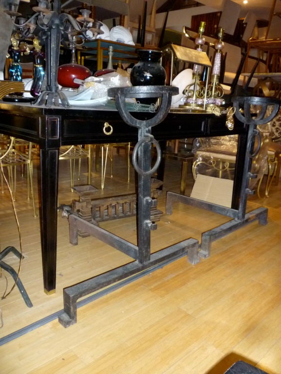 Unusually large pair of neoclassic french andirons in wrought iron with a very neat design.