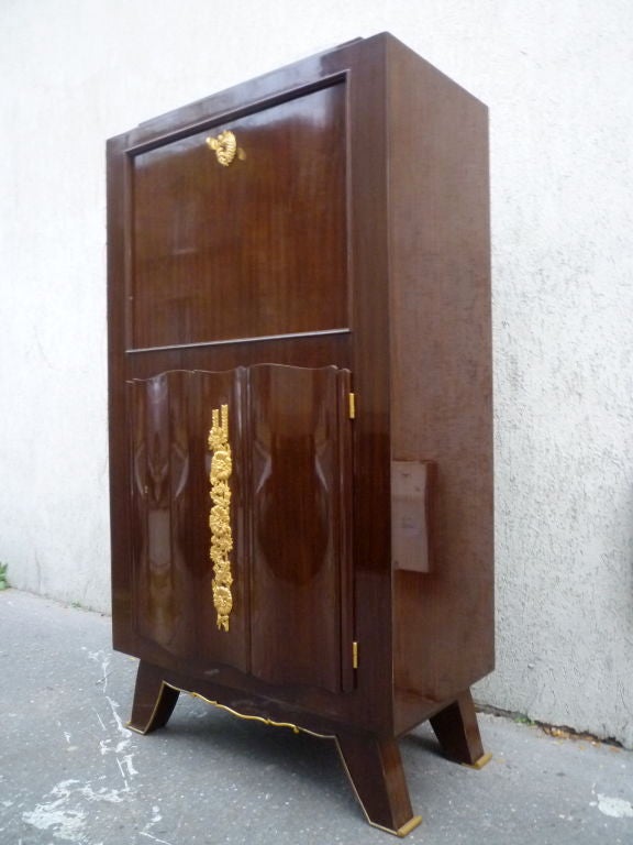 Very refined bar cabinet signed Jules Leleu in mahogany and gold bronze hardware

in legs, doors and keyhole.