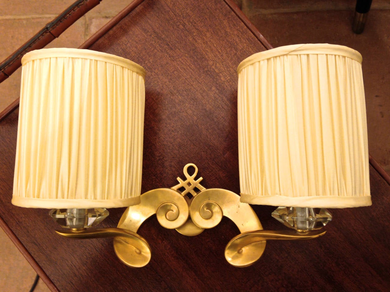 Maison Leleu signed pair of gold bronze and crystal sconces with silk pleated shades.