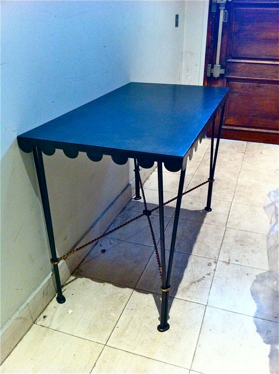 Gilbert Poillerat desk and its chair in oxidised and gold leaf wrought iron.