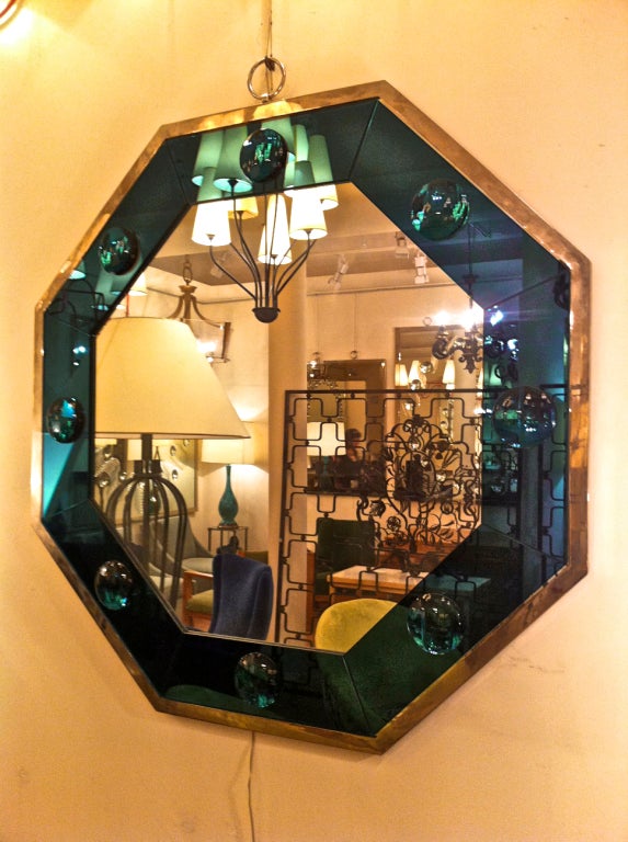 Octagonal silvered frame mirror with deep blue insert and silvered ring hanger.