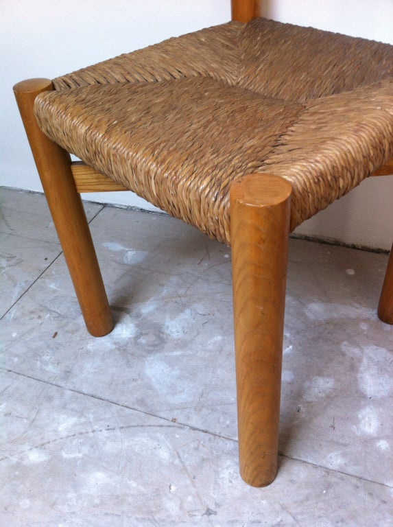 Charlotte Perriand set of four wood and rush seat chairs.