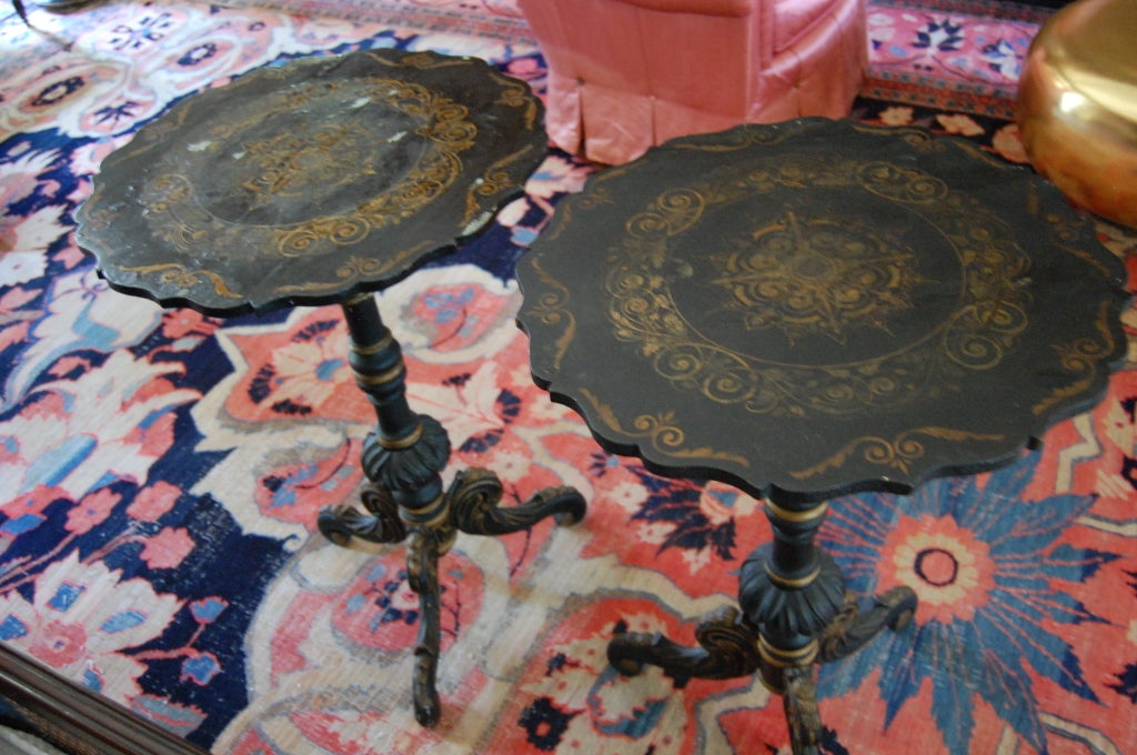 Pair of chinoiserie Swedish tilt-top tables with scalloped top resting on a turned tripod pedestal base. Gold leaf decoration on the top and base.