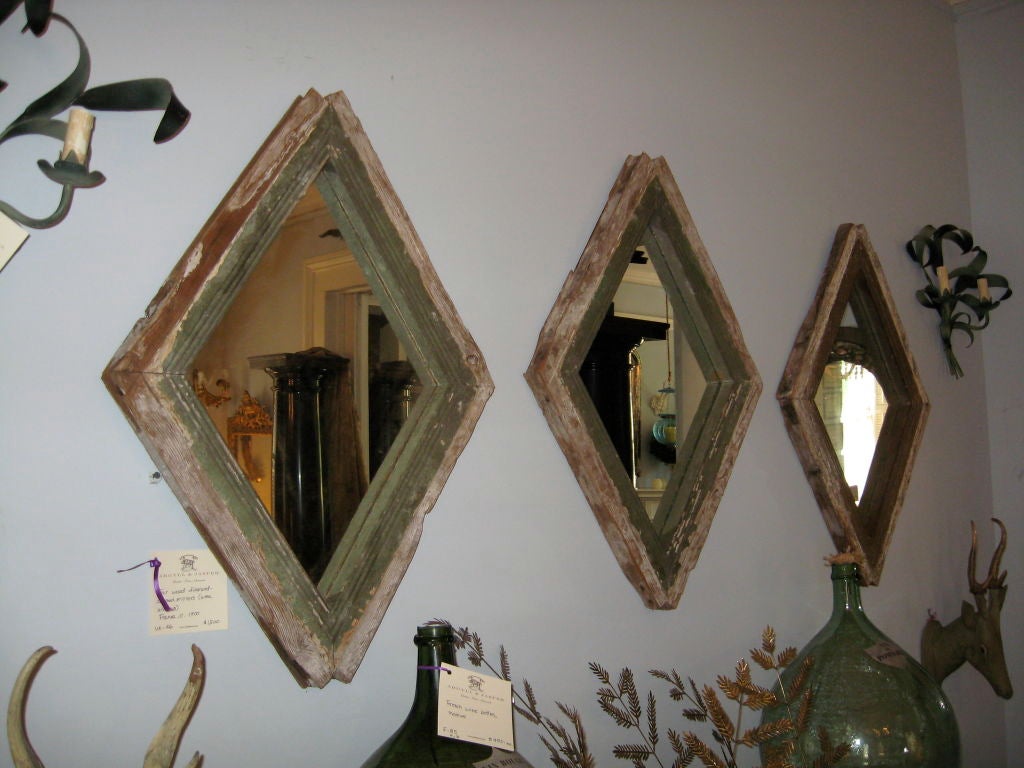 Four French diamond-shape painted and distressed wood frame mirrors which were formerly windows.  The mirror is new; the frames are 19th century.