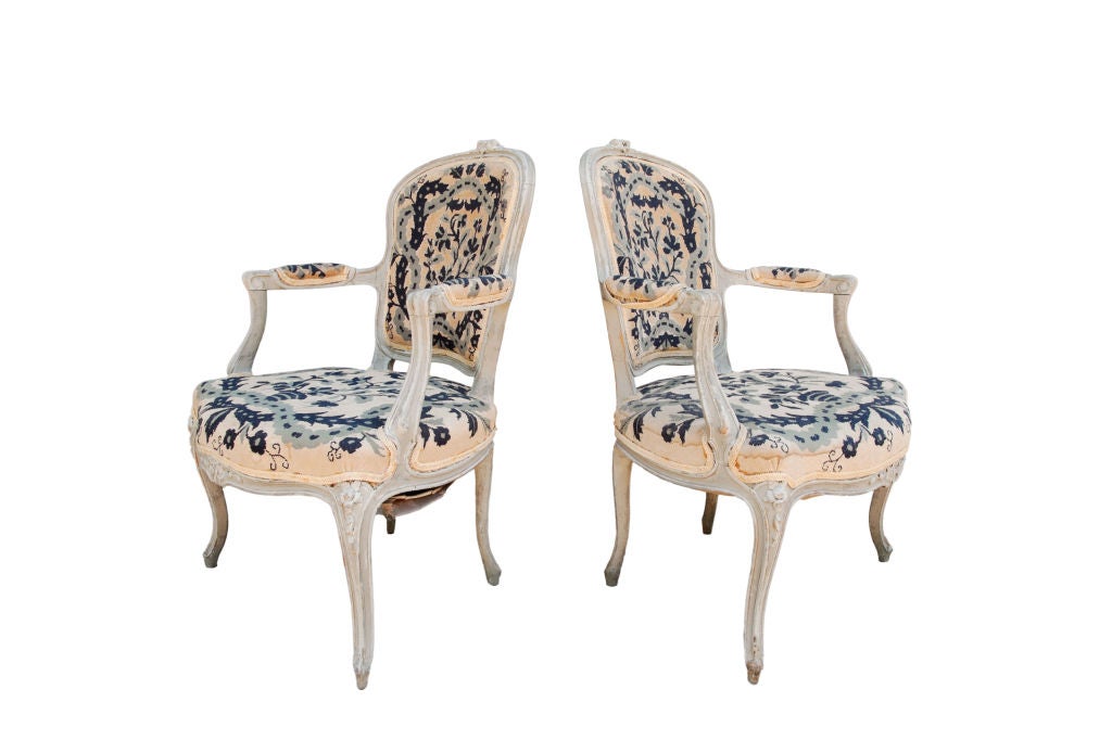 Charming pair of limed fauteuils with cabriole legs and blue needlepoint.