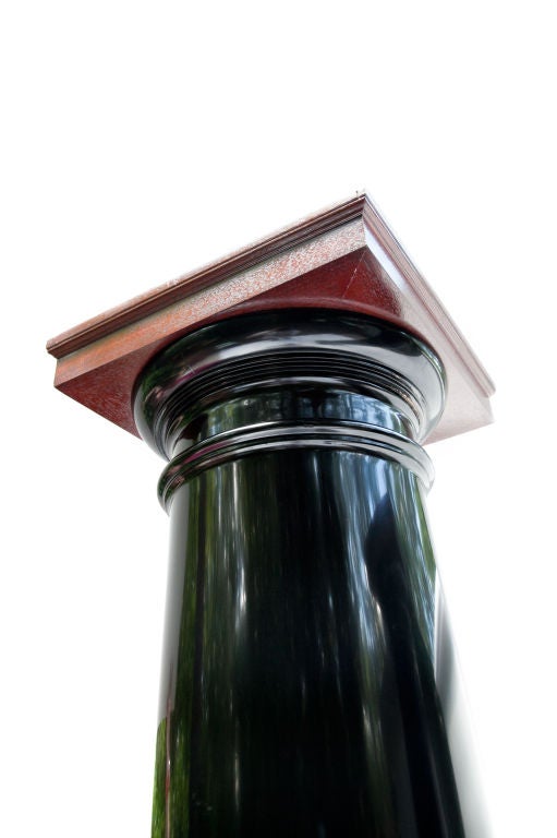 Eight black lacquered wood columns ($16,000 for eight) with mahogany caps and bases. The column is hollow with multi-strips of hand-hewn wood pieced to form the column and visible when looking down into the column from the top. Base is 16 1/4