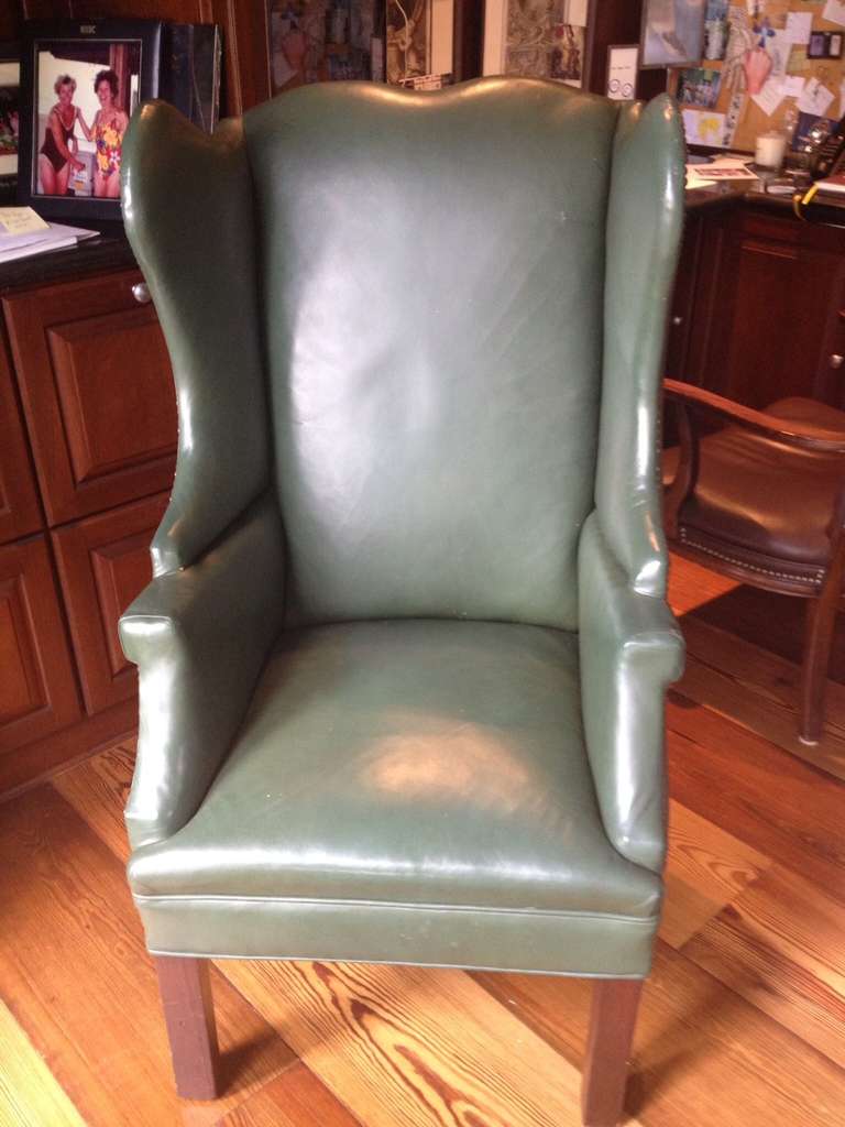 Small (ladies) wingback chair made in Savannah in 1930. Reupholstered in 1980 with leather hide for Bentley automobile. Brass nailheads. 
NB: The leather on the chair seat is not faded, as it appears in the photo. This is a light reflection; the