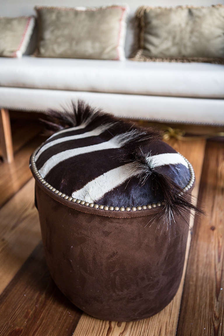 Vintage zebra on contemporary ottoman. Ottoman upholstered in ultra-suede and zebra skin with brass nailheads. The zebra mane is on top of the ottoman and the head is incorporated on the side.