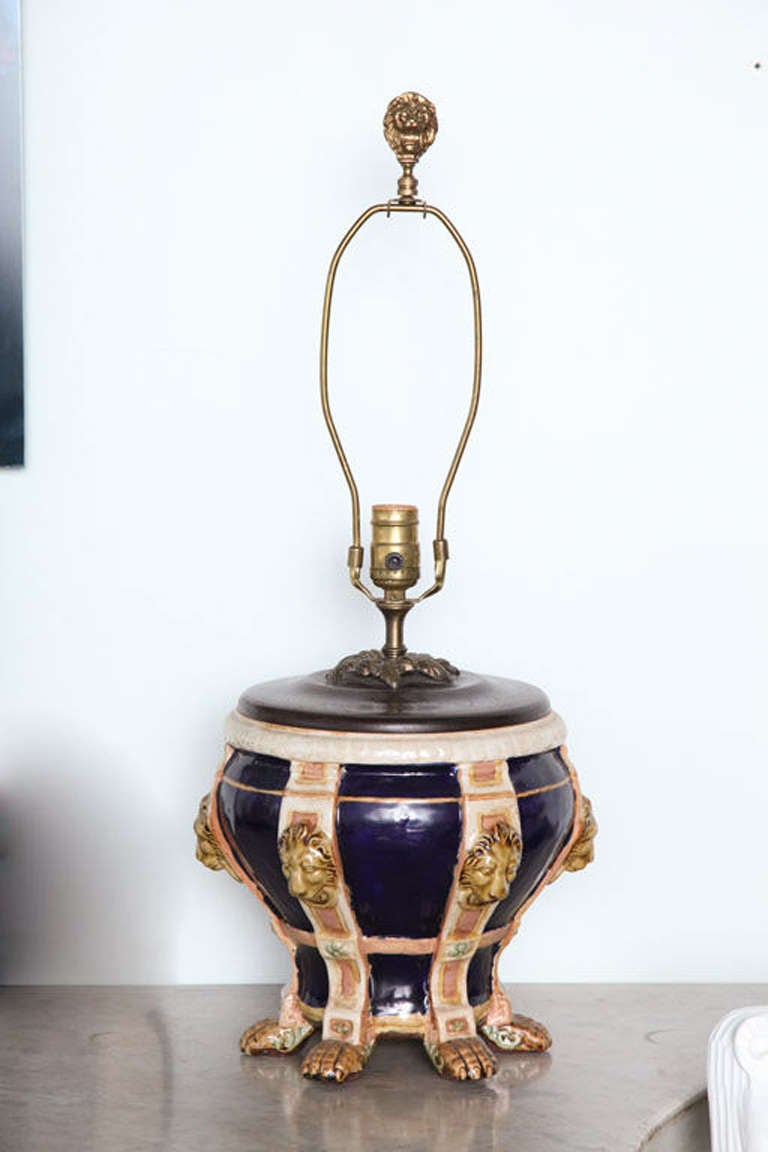 The cobalt ground divided by lion heads terminating on paw feet- now mounted as lamps. Measurement to top of finial 25.5