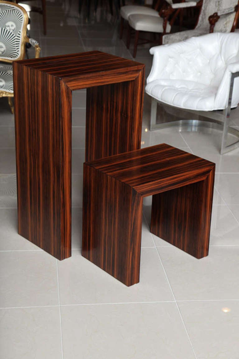 Ebony de Macassar pedestal and table, France. Each measures 20