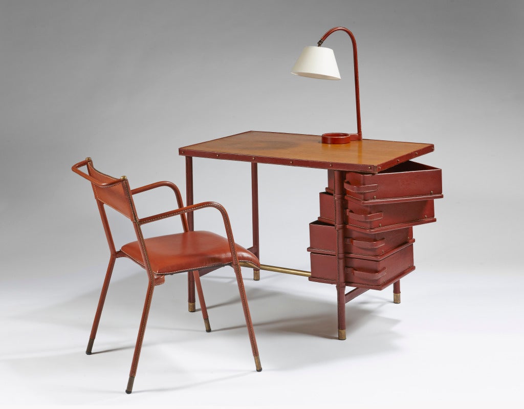 Elegant desk, with metal structure sheathed of burgundy saddle stitching leather, pivoting drawer, with his chair and lamp
