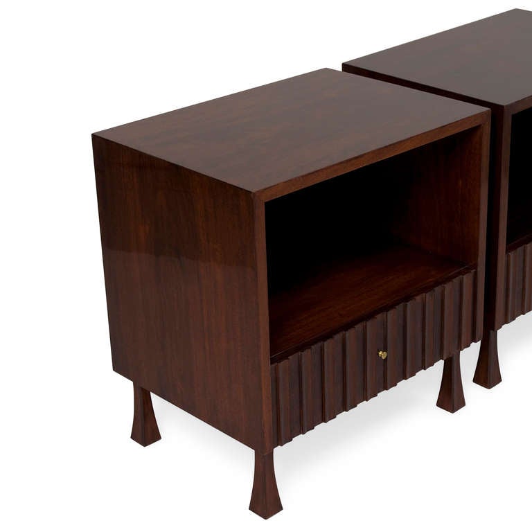 Pair of single drawer mahogany end tables, with open storage compartment above drawer, the face of drawer fluted and having a brass pull, the case resting on inverted tapered legs, by Widdicomb, American 1970s. Width 22 in, depth 16 in, height 23