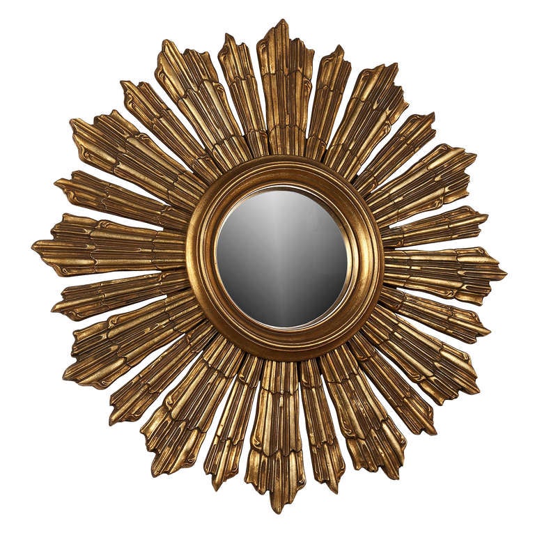 Sunburst form mirror, solid wood, gilt, with center bombe mirror. French 1950s. Heavy and of good quality. Overall diameter 25 1/2  in, diameter of mirror 7 1/4 in. depth 1 in. (Item #1978)