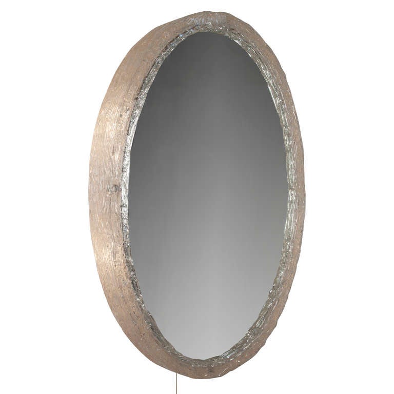 Threaded acrylic resin oval frame mirror, the mirror frame formed by composed threads of acrylic resin, illuminated with a on/off pull string, German 1970's. Height 28 1/2 in, width 22 in, depth 3 1/2 in. (Item #2012)
