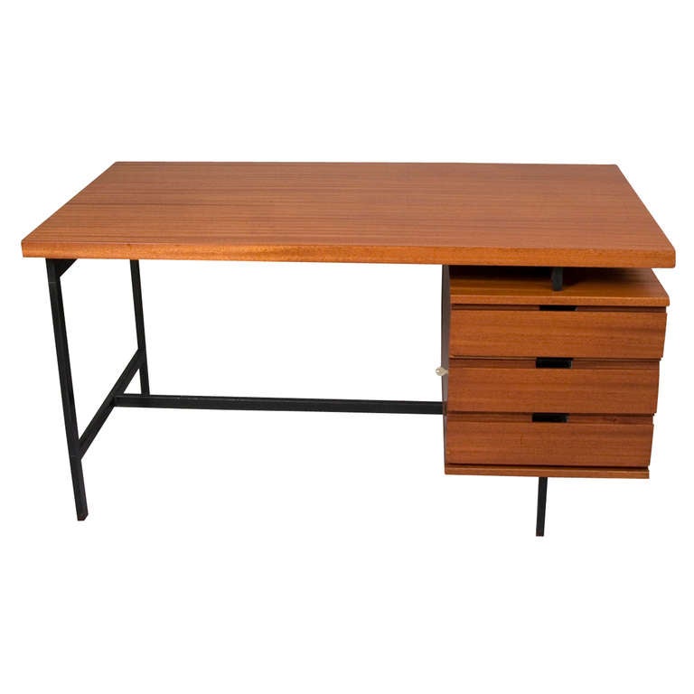Acajou three flanking drawer platform desk, on squared black lacquered iron frame, and having slip storage space above drawers, finished on all sides, and the drawers locking if desired, by Pierre Guariche for Minivielle, French 1964. Marked with