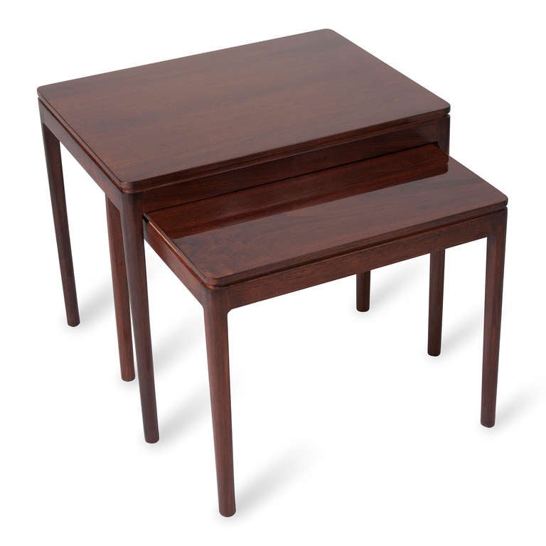 Set of two solid mahogany rectangular nesting tables, with tapered dowel legs, and lip groove, by Drexel, American 1950s. Large: 20 in x 24 in x 18 in, smaller: 17 in x 21 in x 18 in. (Item #1727)