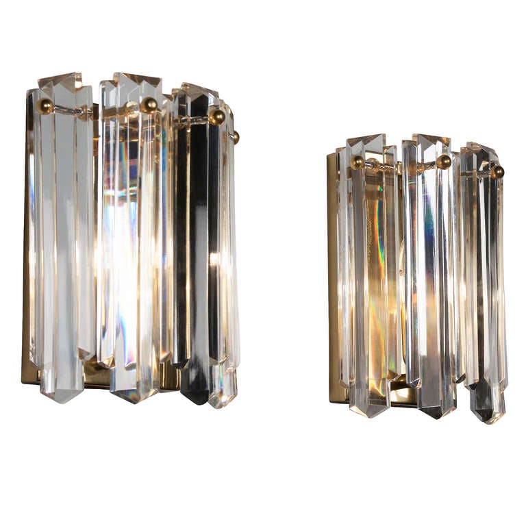 Pair of hanging crystal rod and brass wall sconces, roughly rounded shape mounted on brass wall mounted fixture, by JT Kalmar, Austrian 1970's. Height of rods 9 in, with of glass rods 2 1/4 in. Brass backing fixture measures 8 x 5 in. Overall width