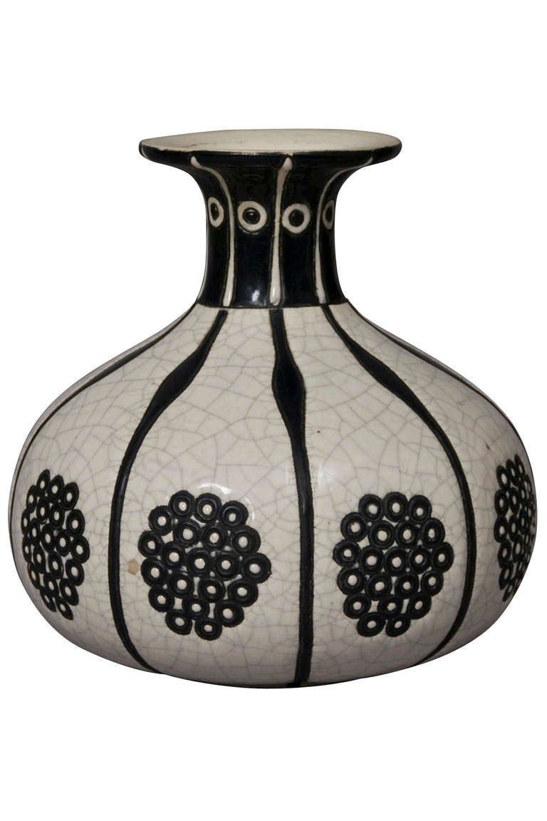 Pinched neck flared rim bulbous ceramic vase, the off white crackle glaze decorated with black floral flourishes and bands, by Longwy, French circa 1925. Stamped to underside Longwy France. Height 6 in, diameter 6 1/8 in. (Item #1352)